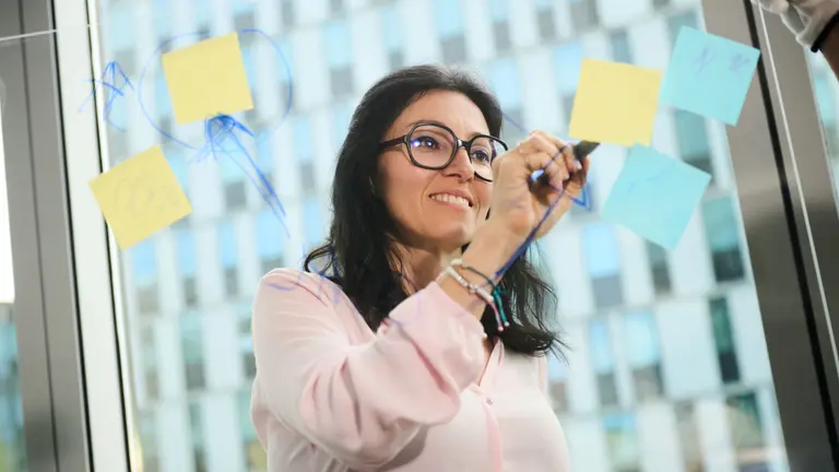 A woman drawing something on a board