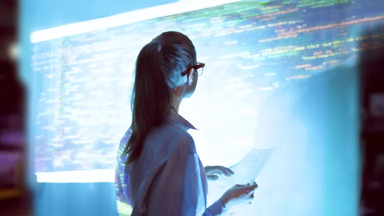 A woman standing in front of a video wall